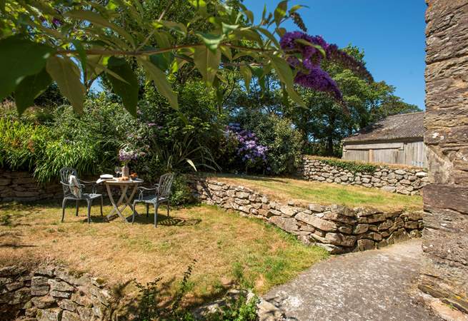 The garden is terraced and has a slope at the bottom.