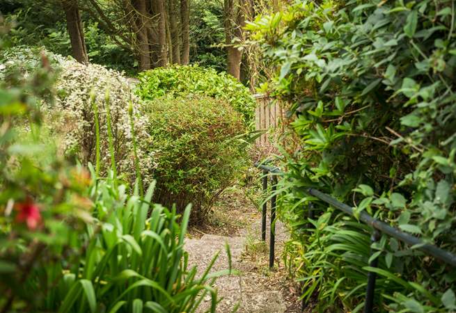 Take the steps, and follow the path down through the terraced garden to the gate at the bottom, for a shortcut to the cove.