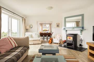 The sitting-area features a warming wood-burner and large flat screen television.