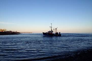 A homeward bound fishing boat entering the Estuary.
