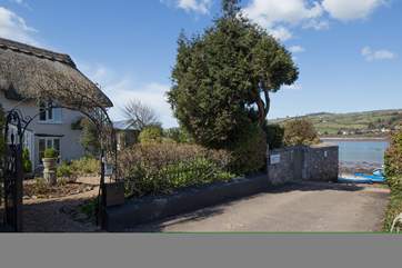 The front of the cottage with the slipway to the right. Parking is opposite the house.