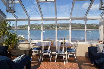 The conservatory is where you will spend your time looking out over the water.