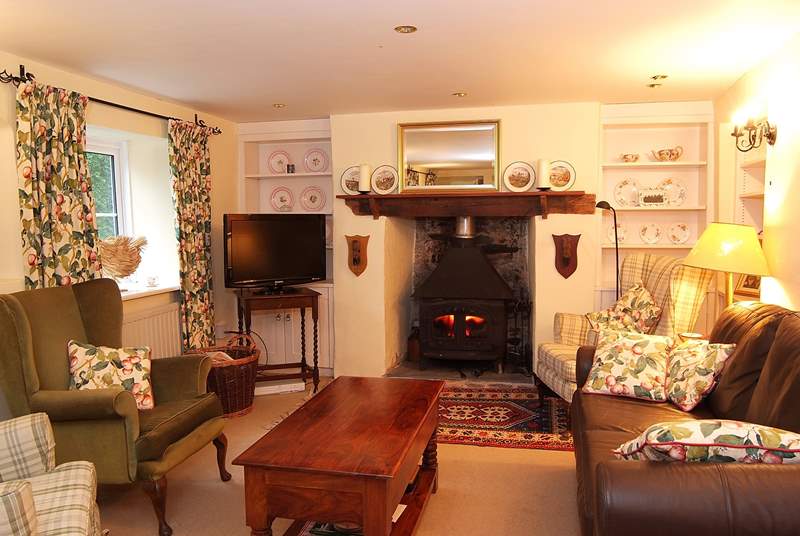 The elegant sitting-room has a wood-burner at each end.