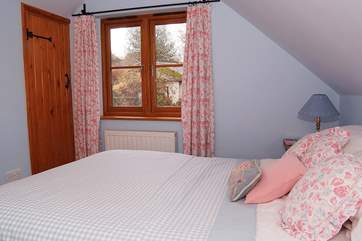 Bedroom 2, the double bedroom, overlooks the secluded garden.