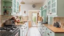 The entrance to the cottage leads up into the lovely country-style kitchen.