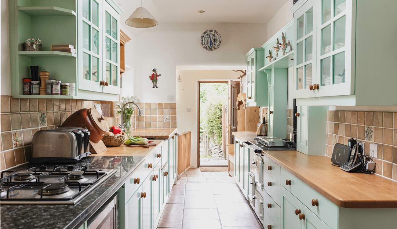 The entrance to the cottage leads up into the lovely country-style kitchen.