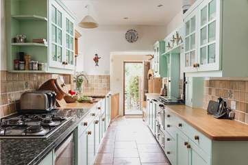 The entrance to the cottage leads up into the lovely country-style kitchen.