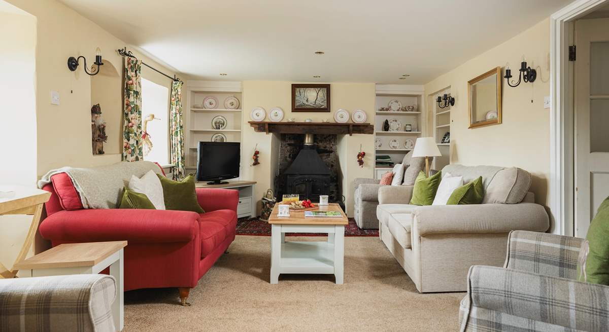 The elegant sitting-room has a wood-burner at each end.