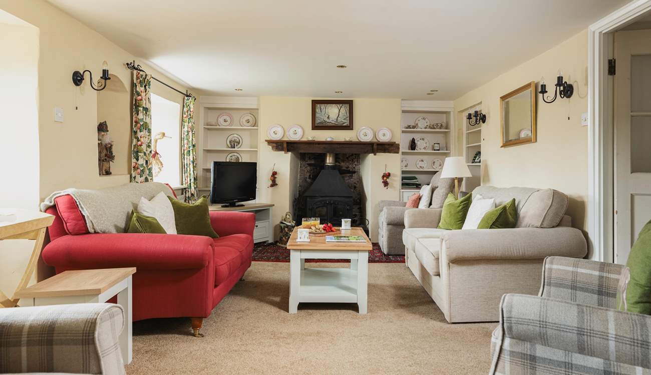 The elegant sitting-room has a wood-burner at each end.