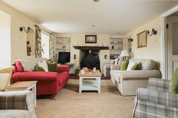 The elegant sitting-room has a wood-burner at each end.