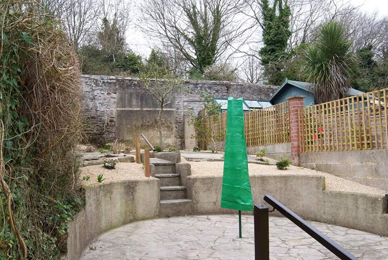 The gravelled, terraced rear garden (take care on the steps) has a patio-area.