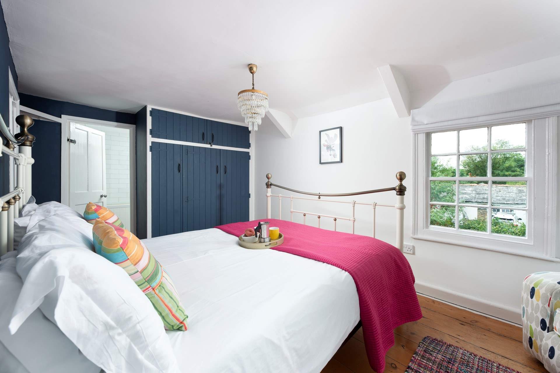 The pretty paned windows in the main bedroom fill the room with light.