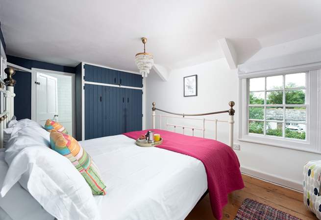The pretty paned windows in the main bedroom fill the room with light.