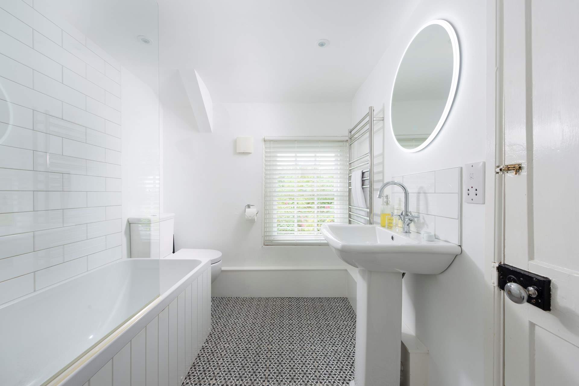 The cottage has a stylish bathroom with a bath.....
