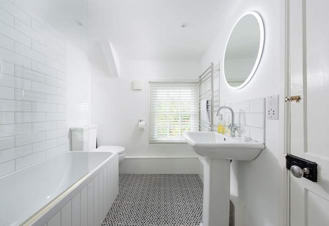 The cottage has a stylish bathroom with a bath.....