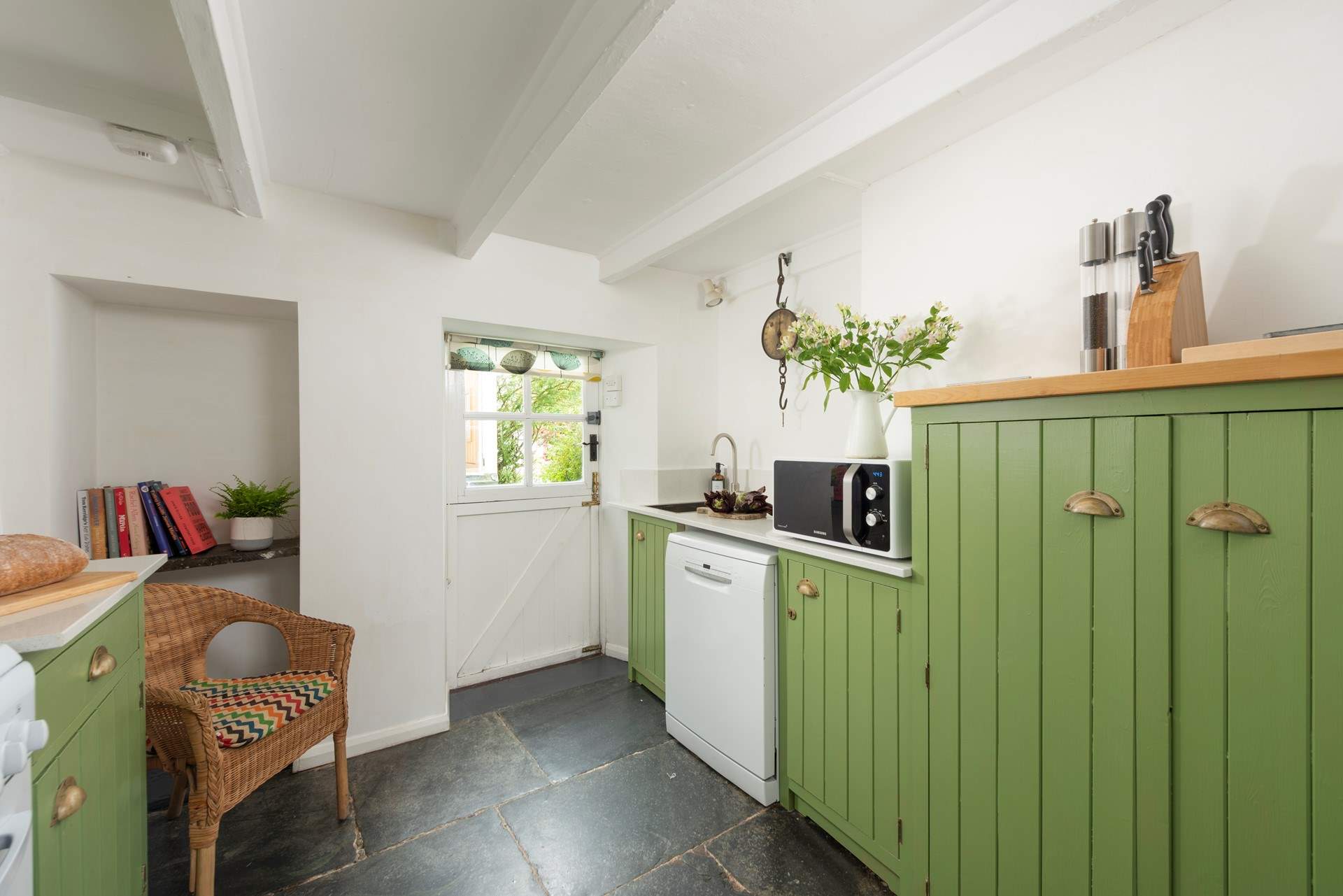 A country kitchen with the beautiful wooden beams you would expect to find. 