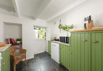 A country kitchen with the beautiful wooden beams you would expect to find. 