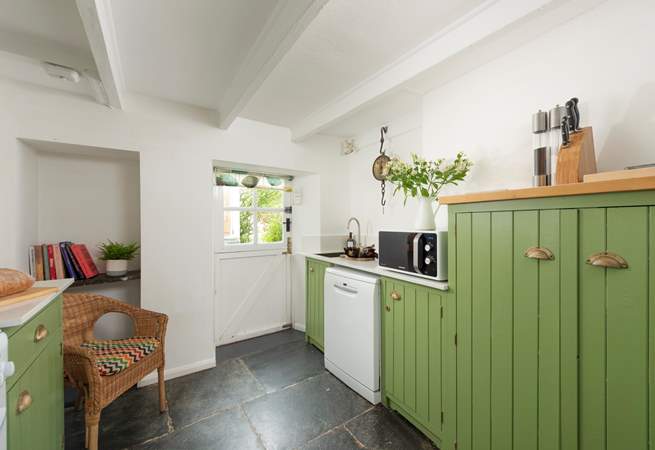 A country kitchen with the beautiful wooden beams you would expect to find. 
