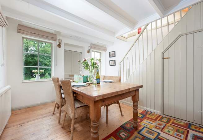 The polished pine dining-table sits at one end of the open plan living-room.