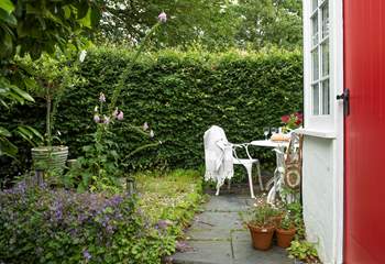 A delightful little seating area in this country cottage garden. 