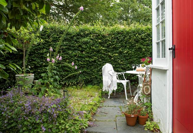 A delightful little seating area in this country cottage garden. 