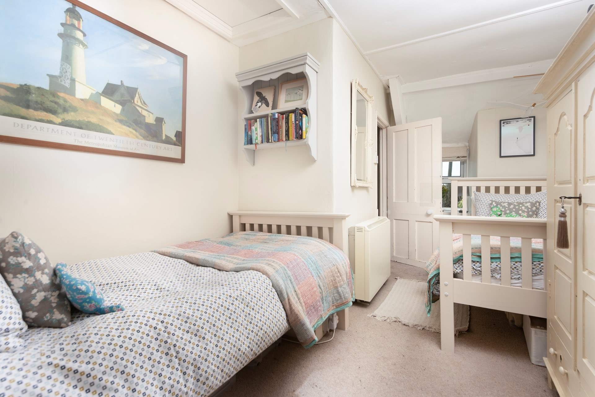 The twin bedroom is light and airy and has plenty of storage.