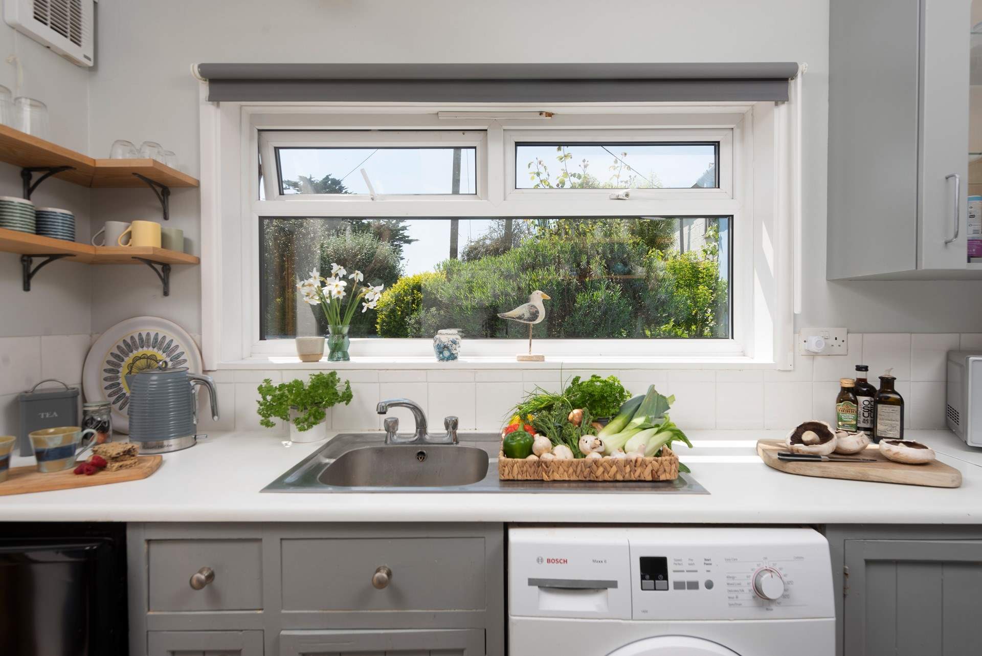 The kitchen looks out onto the back garden and patio.