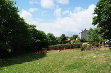 The view from the patio across the meadow garden, with the cottage parking-area and the end of the owners' house just in the picture on the right.