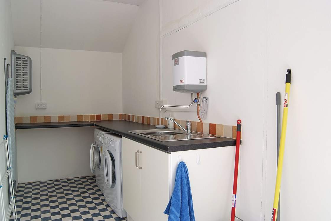 The separate utility-room is located behind the cottage next door.