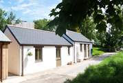 The exterior of pretty little Kernel's Barn, with the separate utility-room to the rear of the building next door, on the left.