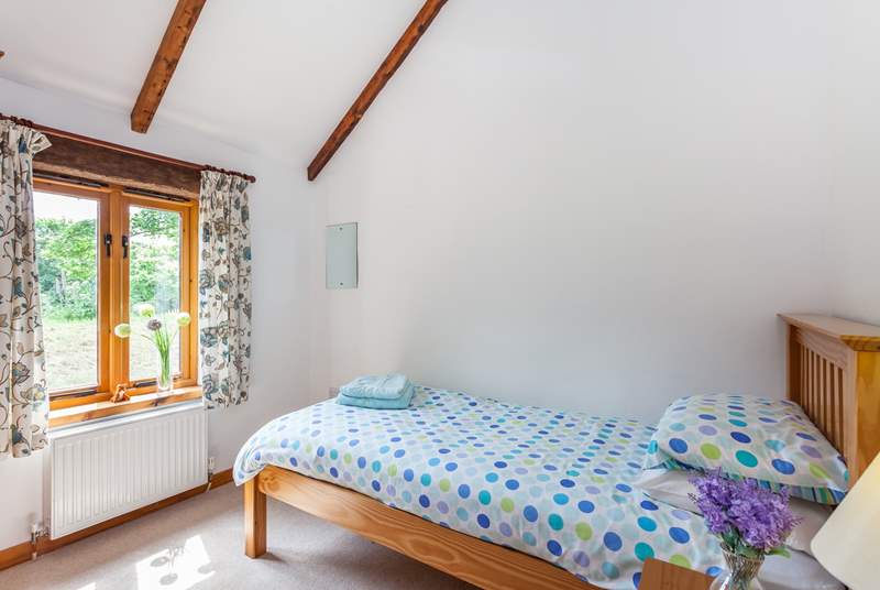The cute second bedroom is suitable for an adult or child.