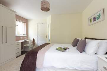 There is plenty of storage space.The door leads to the wet-room.