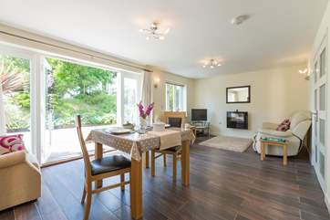 There is a light-filled, open plan living/dining-area with French windows to the sunny patio.
