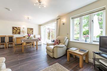 Another view of the open plan living space - plenty of room, bright and contemporary with two comfortable reclining armchairs as well as a sofa.