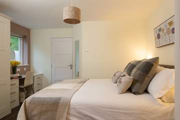 There is a fitted dressing table and plenty of wardrobe space. The door leads to the wet-room style shower-room.