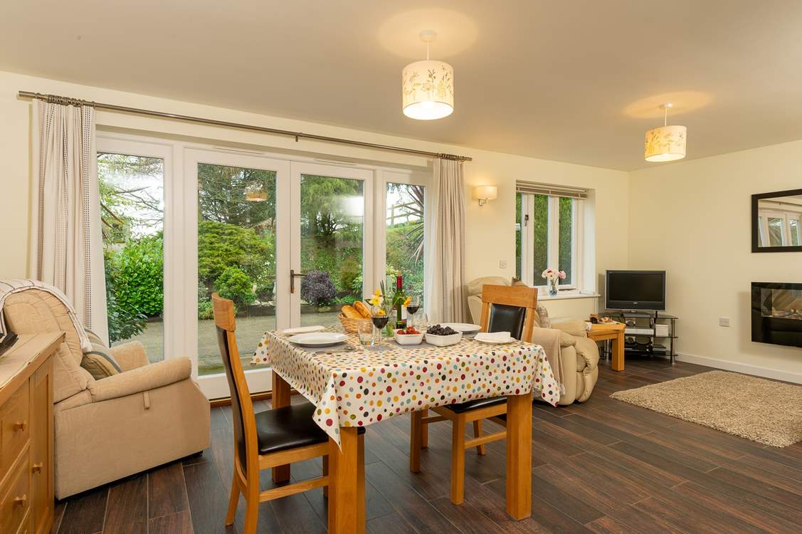 The bright and spacious open plan living space has French windows out onto your patio.