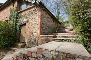 The stone steps up the side of the barn lead to your enclosed garden. A useful option but do take care as the steps can be slippery if wet. They are shallow and wide but there is no handrail.