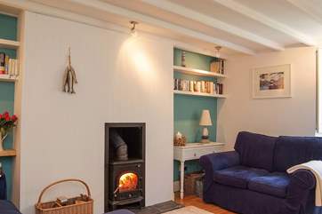 The comfortable sitting-room has a roaring wood-burner.