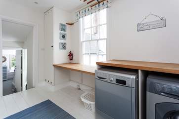 Four steps lead up from the lower landing into this large area, where you will find a very handy utility area with a drier and washing machine.