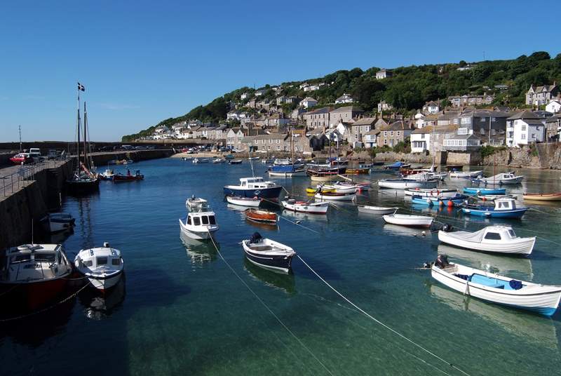 Step outside of Pender Cottage and onto the harbour edge in Mousehole.
