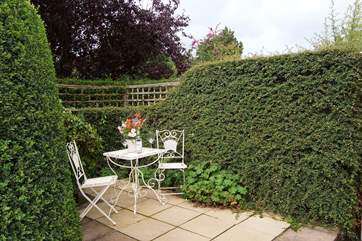 Enjoy your morning coffee in this sheltered spot behind the cottage.