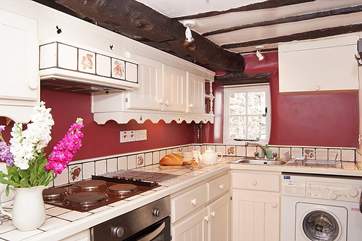 The galley-style kitchen has access to the private patio at the rear of the cottage.