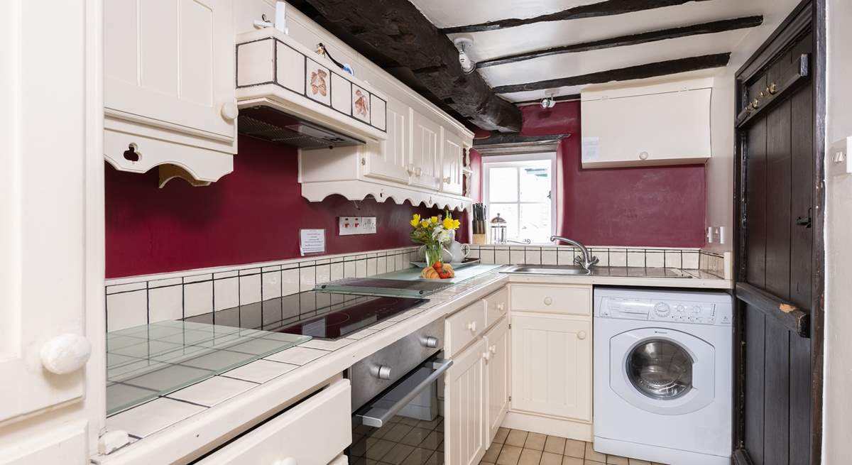 The galley-style kitchen has access to the private patio at the rear of the cottage.