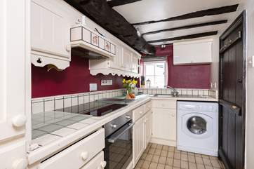 The galley-style kitchen has access to the private patio at the rear of the cottage.