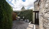 A view of the very sheltered patio at the rear of the cottage. - Thumbnail Image