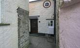 The black is the front of Lane Cottage with cute feature window - the key safe and back door are around to the left, down the passage. - Thumbnail Image