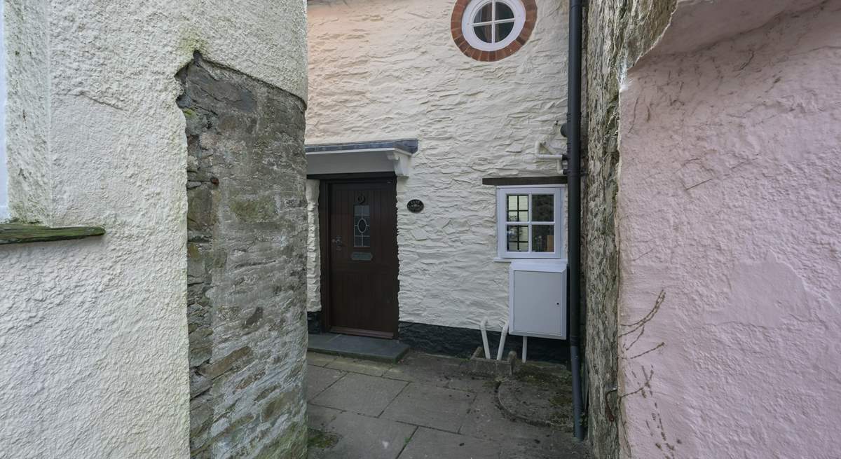 The black is the front of Lane Cottage with cute feature window - the key safe and back door are around to the left, down the passage.