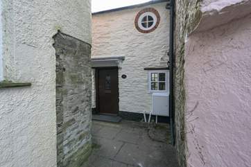 The black is the front of Lane Cottage with cute feature window - the key safe and back door are around to the left, down the passage.
