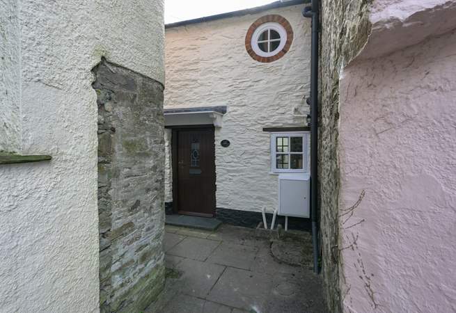 The black is the front of Lane Cottage with cute feature window - the key safe and back door are around to the left, down the passage.