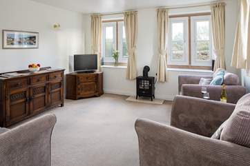 The cosy sitting-room has a wood-burner effect electric stove heater.